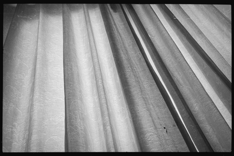 Elegant curtains with intricate patterns in a monochrome aesthetic.